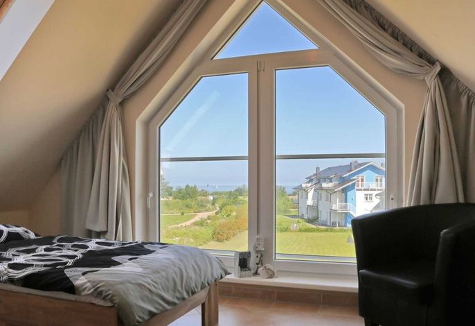 Photo Strandapartment – Meerblick trifft knisterndes Kaminfeuer 1