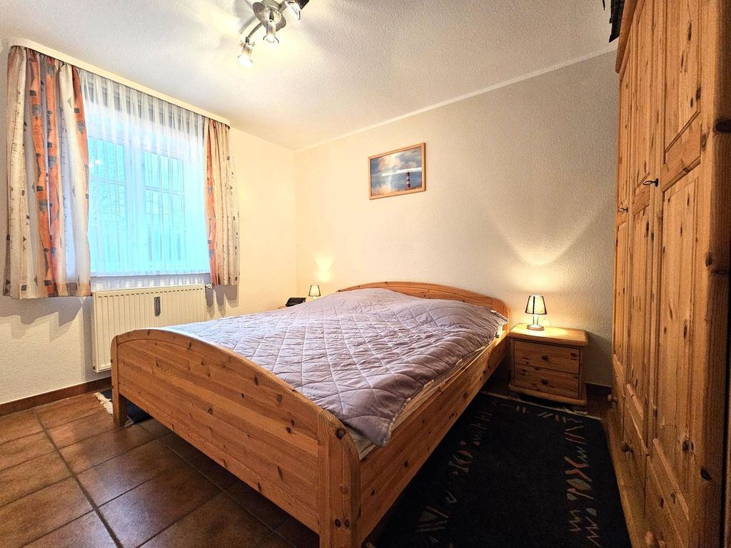 Schlafzimmer mit Doppelbett und Nachttischen.