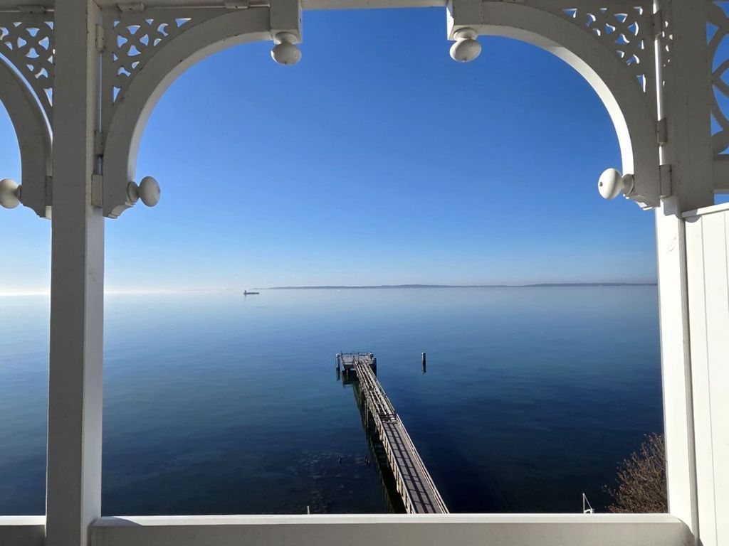 Fürstenhof Sassnitz – Blick von der weiß verzierten Veranda über die Ostsee zur Seebrücke