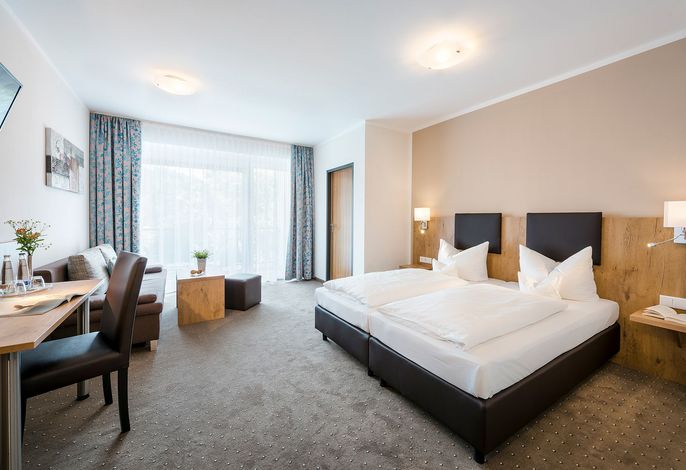 Juniorsuite Standard inkl. Schlafsofa mit Bad/WC, gemütliche Sitzecke