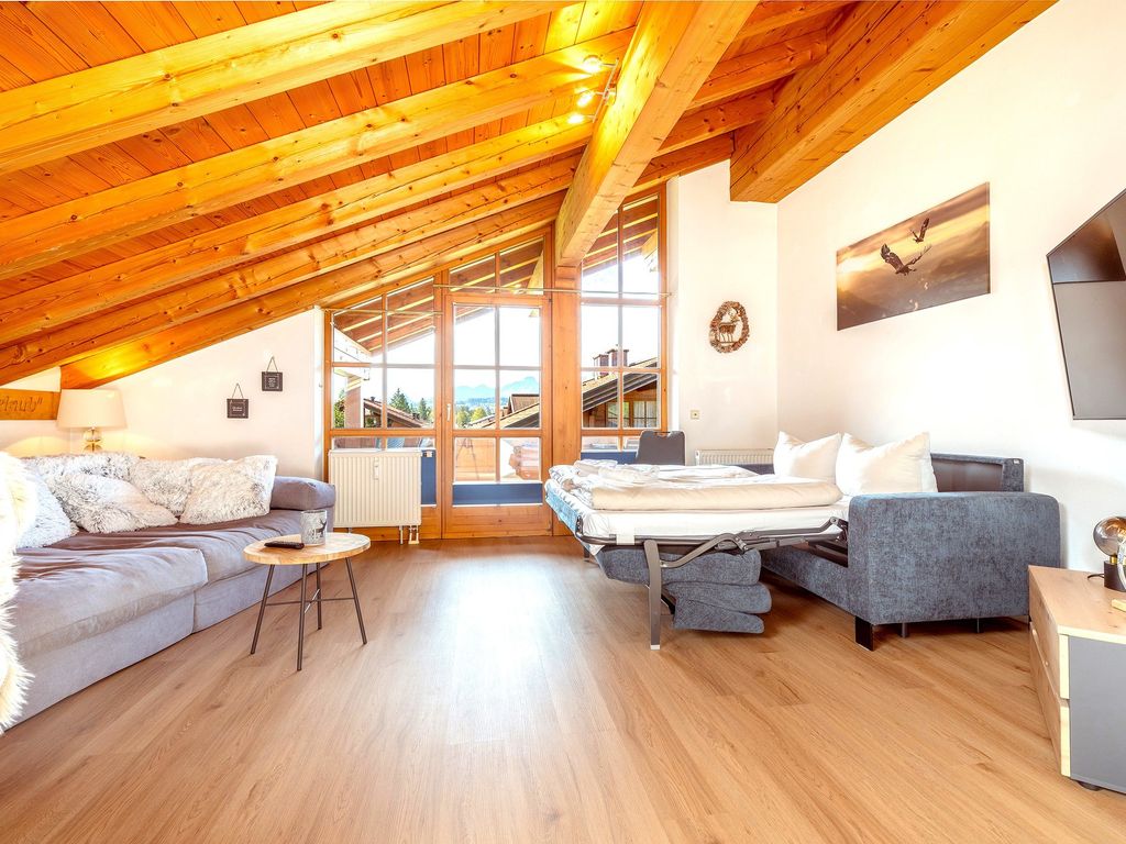 Großer, heller Wohnbereich mit Couch und Schlafsofa (im Bild ausgeklappt)