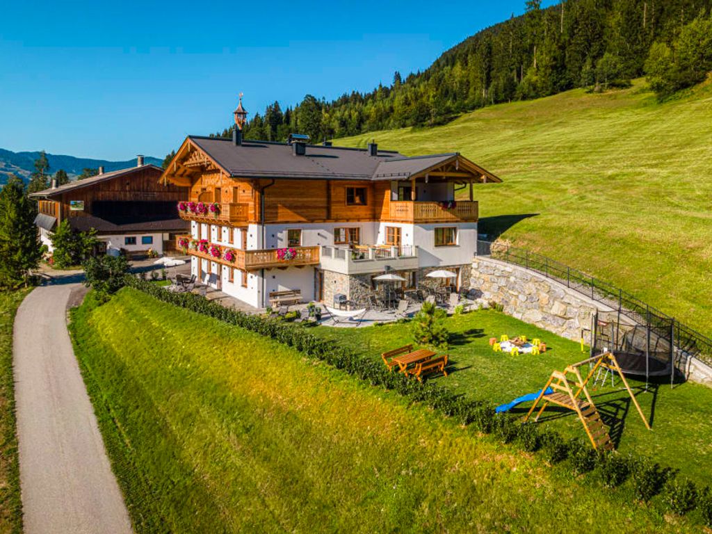 Der einladende Bauernhof besticht durch einen weitläufigen Garten mit Kinderspielplatz und einer sonnigen Terrasse inmitten grüner Natur.