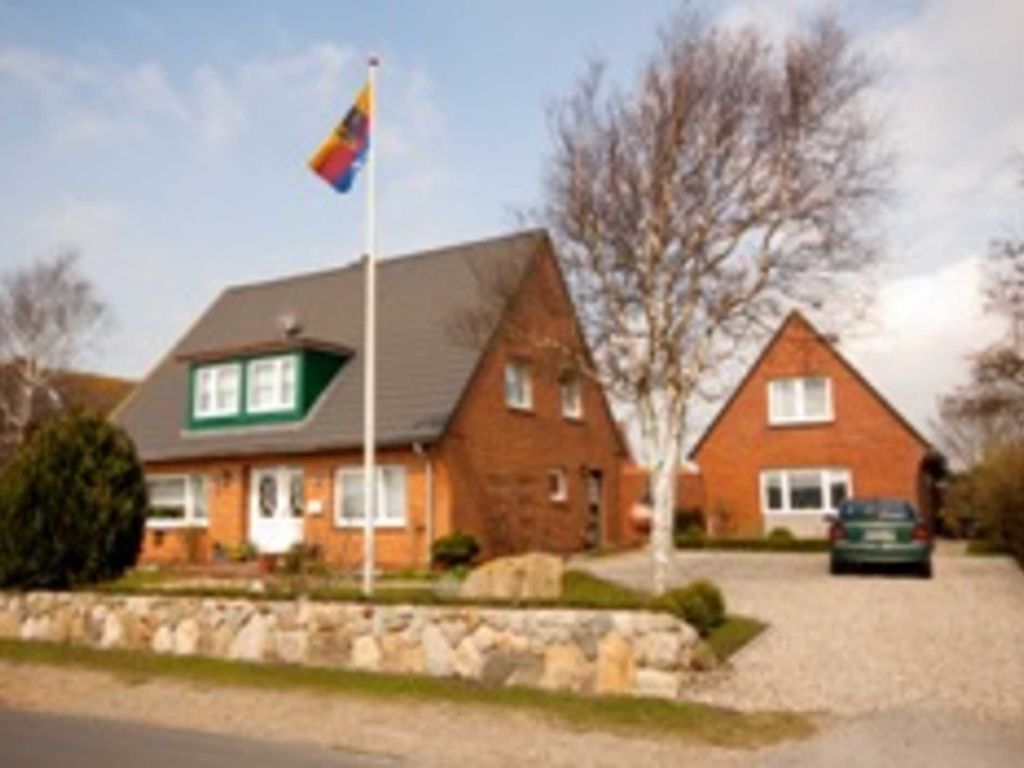 Haus mit Ferienwohnungen und einzeln stehendem Ferienhaus.