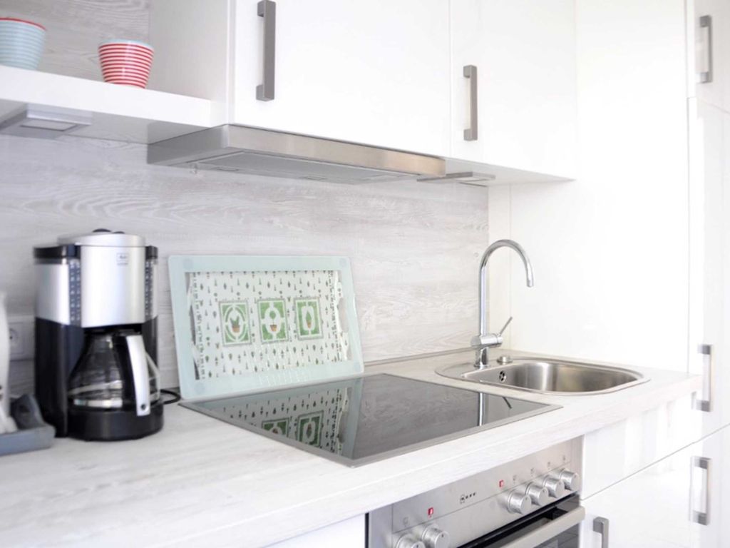 Neue Küche mit Geschirrspüler, Herd mit Backofen und Ceranfeld, Kühlschrank mit Gefrierfach.