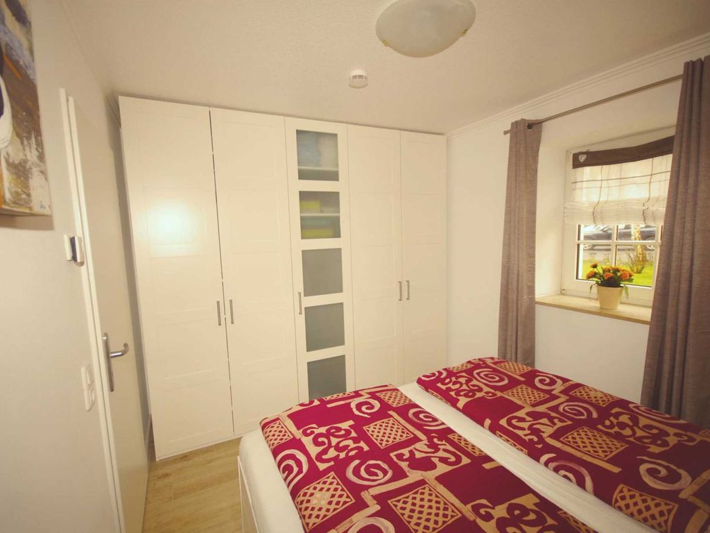 Das Doppelbett kann etwa für Rollstuhlfahrer ohne weiteres an eine der beiden Wände geschoben werden, zwischen Bett und Wand ergeben sich dann 91 cm Durchgangsbreite. Der große Wandschrank hat sehr viele Stauflächen. Beim Kauf von Matratzen (1 x Härtegrad 2, 1 x 3) und Bettzeug wurde auf Allergikerfreundlichkeit geachtet.