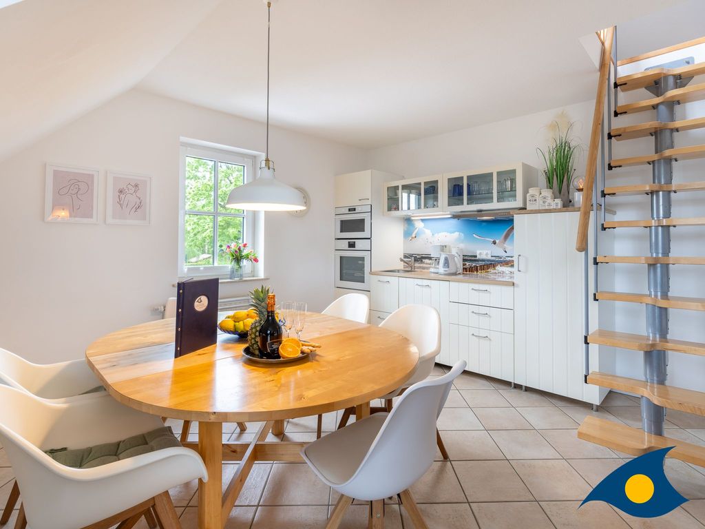 Wohnbereich mit offener Küche und Zugang zum Balkon