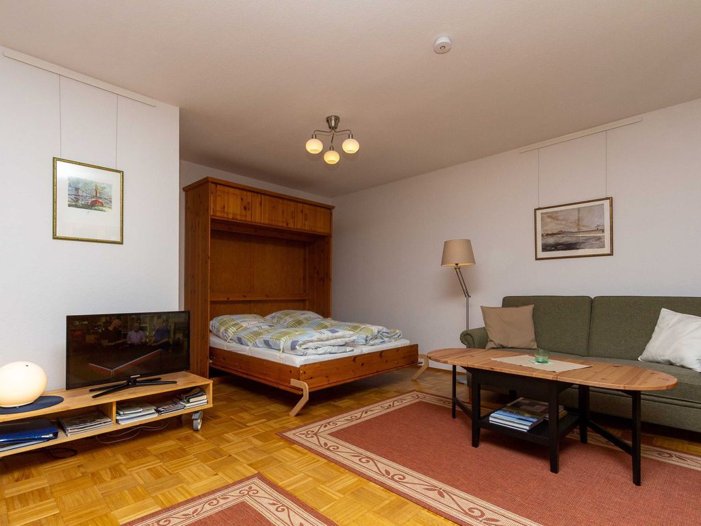Wohnzimmer mit aufgeklappten Bett
