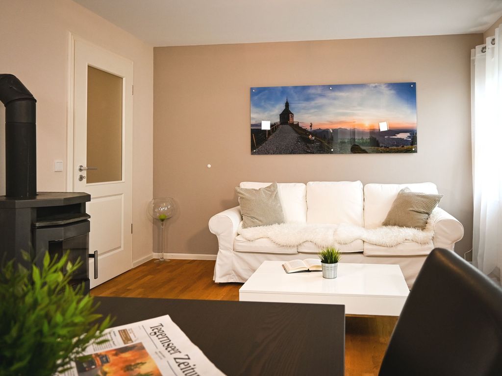Gemütliches Wohnzimmer mit Holzoffen und Essbereich, TV