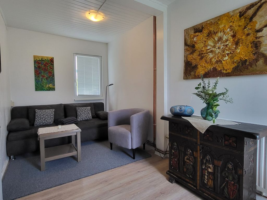 Wohnzimmer mit Couch und Zugang zur Terrasse