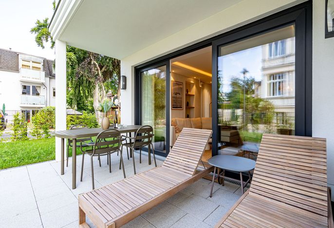 Quartier am Strand Heringsdorf: Terrasse mit Liegen und Essplatz am Garten
