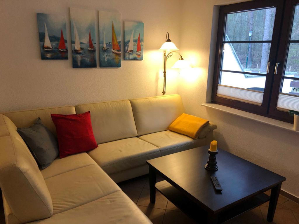 Das Ferienhaus Dünenwald 2 in Karlshagen auf Usedom - 
Das gemütliche Wohnzimmer mit einer hellen, bequemen Sitzgarnitur lädt zum Entspannen und Verweilen ein. Hier können Sie den Tag bei einem guten Glas Wein und kleinen Knabbereien ausklingen lassen und gemütliche Stunden miteinander verbringen.