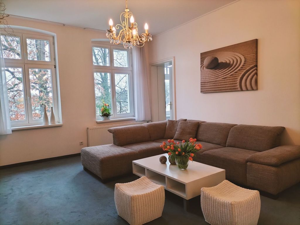 Wohnzimmer mit Eckcouch und Aussicht auf die Häuser von Heringsdorf
