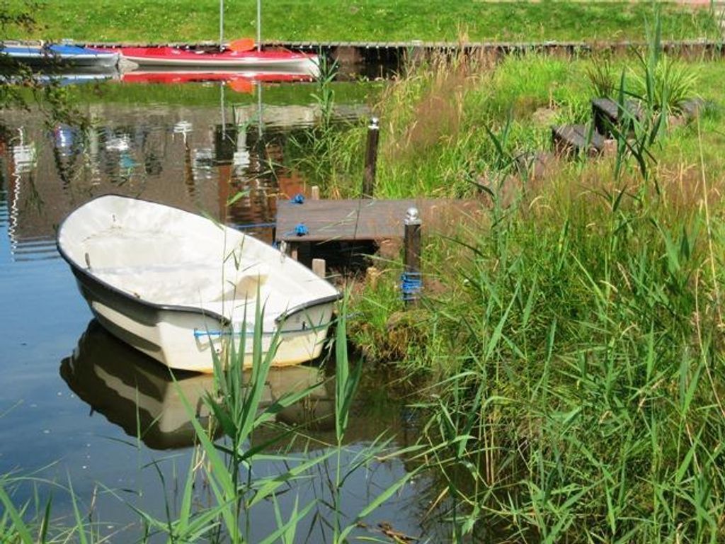 Bootssteg mit Ruderboot direkt am Haus