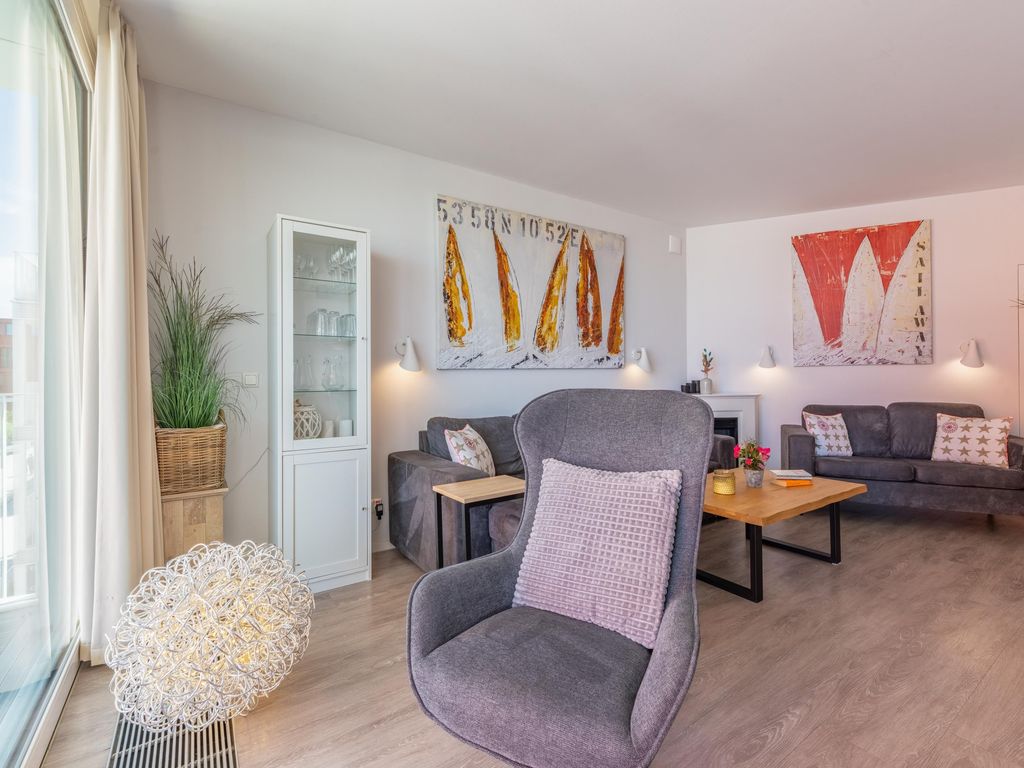 Komfortabler Wohnbereich mit gemütlicher Couch und Sessel.