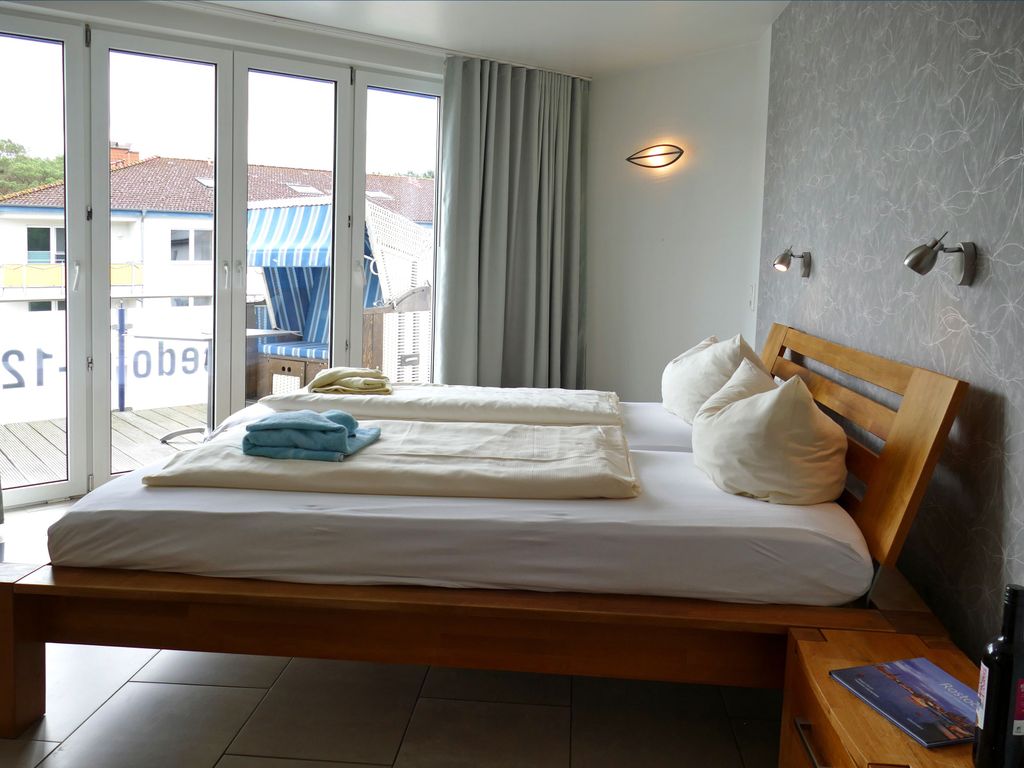 Die großzügige Vierraum-Ferienwohnung erstreckt sich über zwei Etagen und bietet ausreichend Platz für einen erholsamen Aufenthalt. Sie verfügt über drei komfortable Schlafzimmer, zwei Balkone, zwei Badezimmer sowie ein zusätzliches Gäste-WC. Das geräumige Wohnzimmer lädt zum Entspannen und Verweilen ein, während die separate, voll ausgestattete Küche ideale Voraussetzungen für gemeinsame Mahlzeiten bietet.