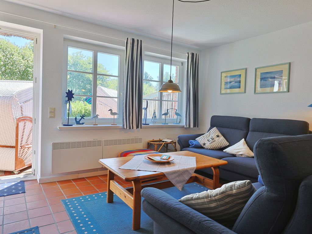 Offener Wohnraum mit Terrassenzugang und Strandkorb