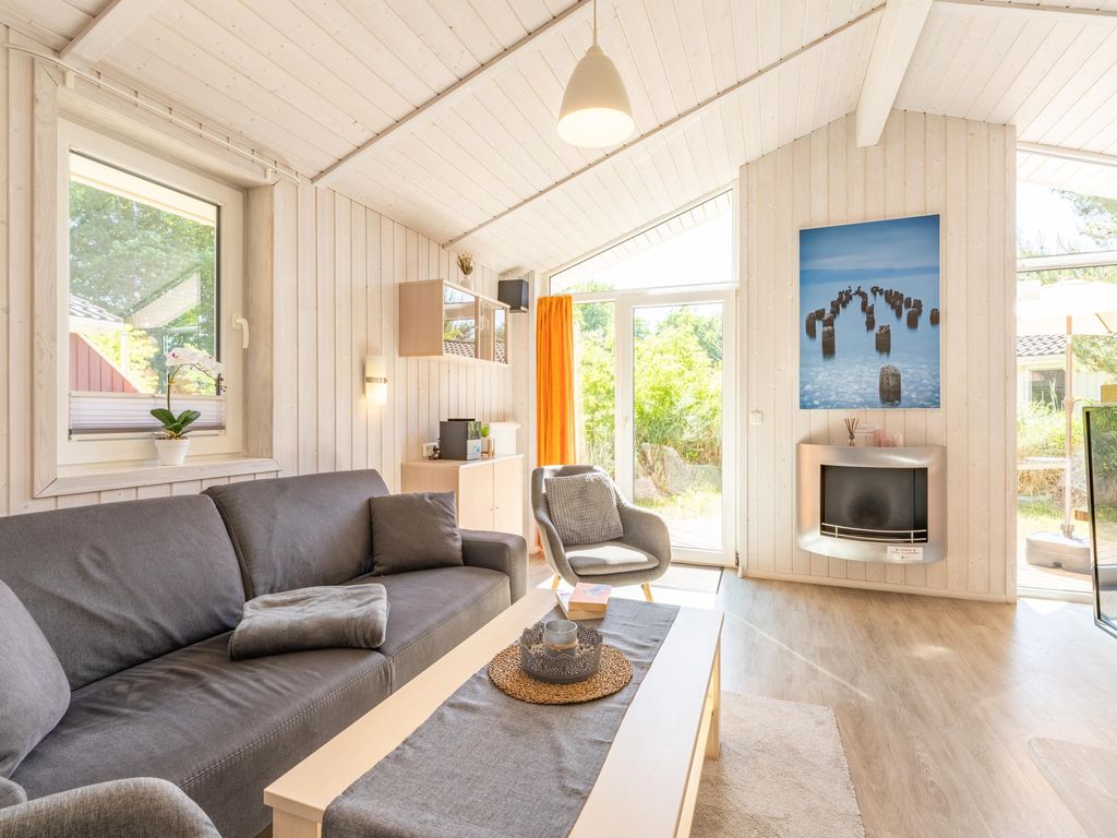 Wohnbereich mit Bioethanol-Ofen, TV und stilvoller Einrichtung.