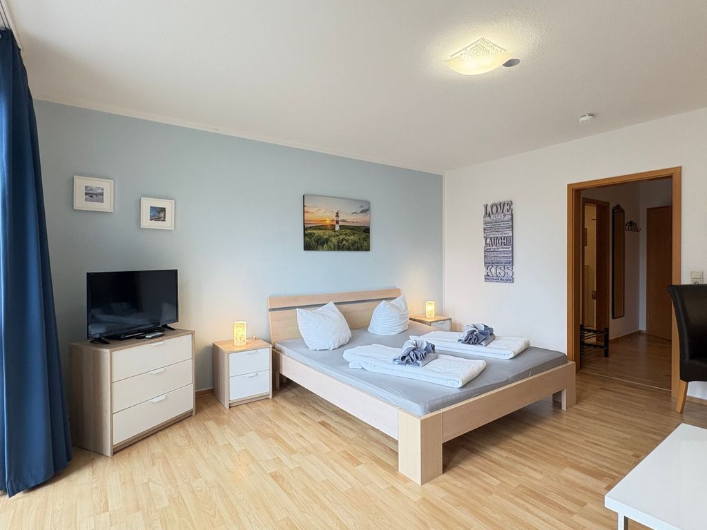 Wohn-/Schlafzimmer mit Doppelbett und Balkon