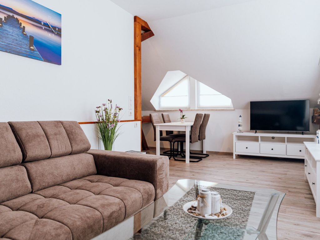 Offener, heller Wohnbereich mit Sitzmöglichkeiten und TV.