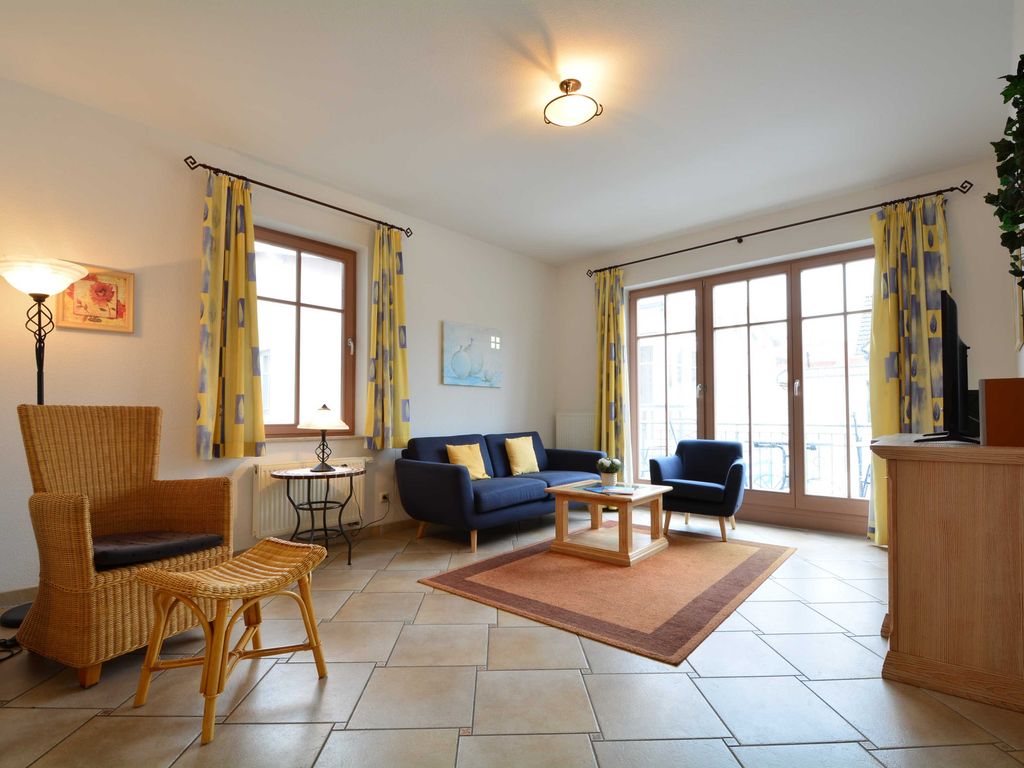 Der Wohnbereich mit Couchgarnitur und Zugang zum möblierten Balkon