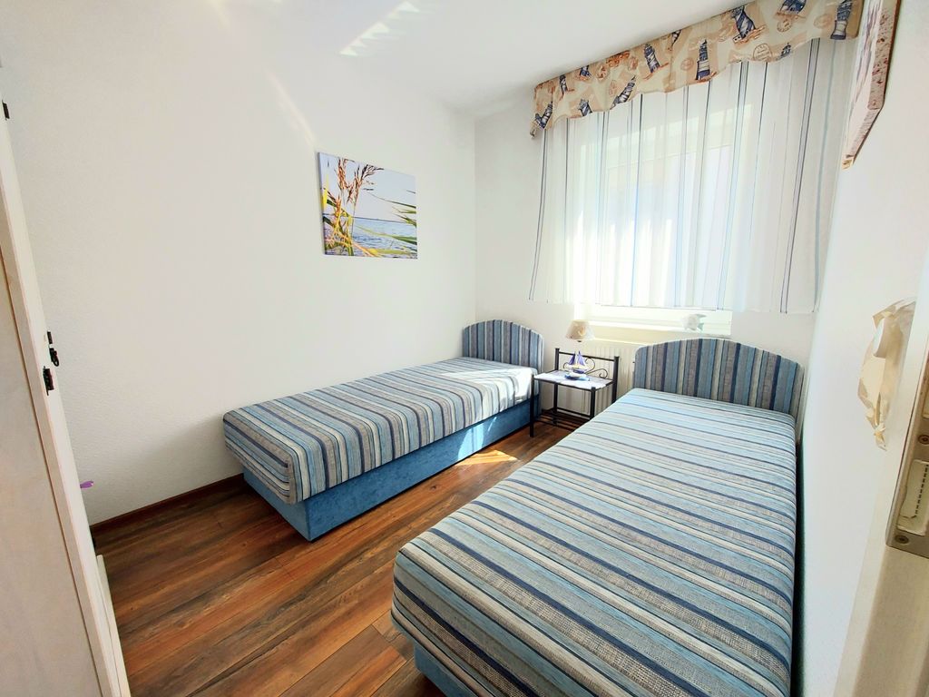 Residenz Mittelstraße 6a Sassnitz – Essbereich mit Strandmotiven und Holzmöbeln