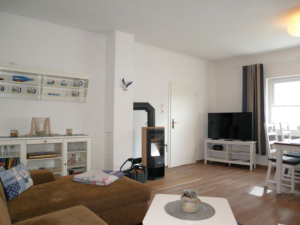 Wohnzimmer mit offener Küche, Essplatz und Kamin