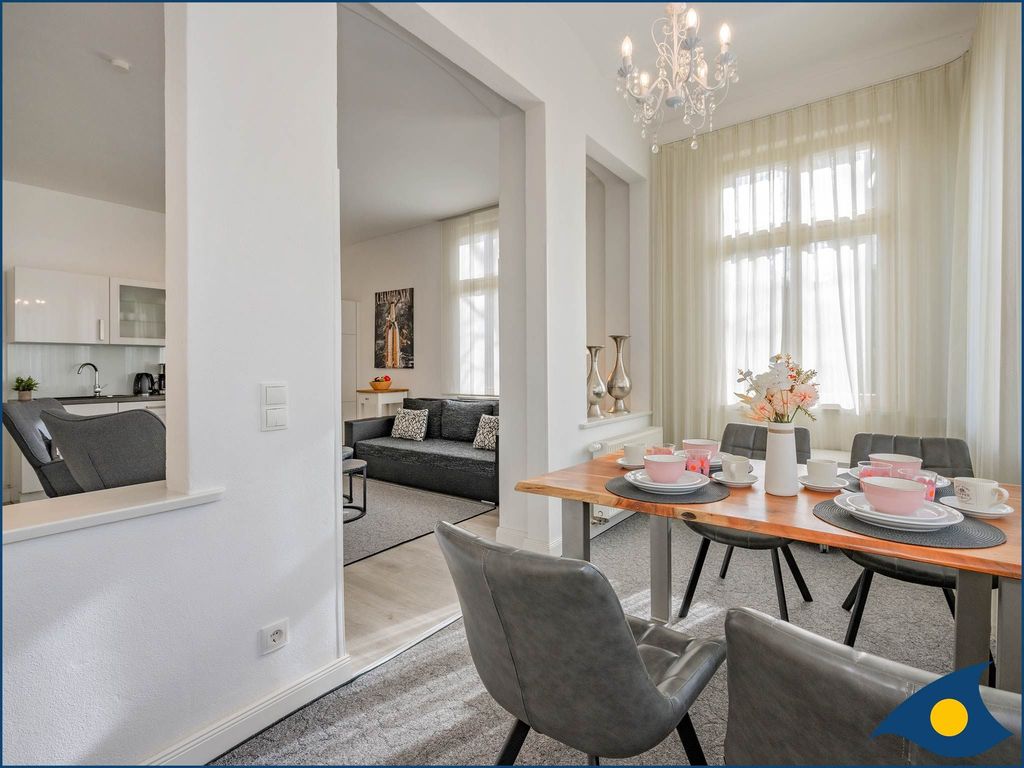 Wohnzimmer mit offener Küche und Zugang zur Terrasse